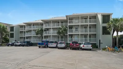 a parking lot in front of a large apartment building at Mistral 12 in Seacrest