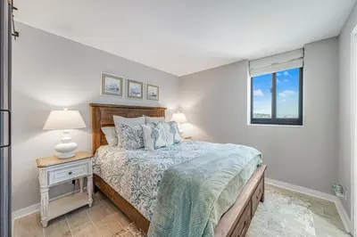 a bedroom with a bed and a window at Newly Completely Renovated Beach Condo at Sunbird Resort! Free Beach Chair and Umbrella Service! by Dolce Vita Getaways! in Panama City Beach