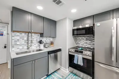 a kitchen with a sink and a stove top oven at Newly Completely Renovated Beach Condo at Sunbird Resort! Free Beach Chair and Umbrella Service! by Dolce Vita Getaways! in Panama City Beach