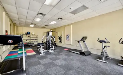 a gym with treadmills and elliptical machines at Newly Completely Renovated Beach Condo at Sunbird Resort! Free Beach Chair and Umbrella Service! by Dolce Vita Getaways! in Panama City Beach