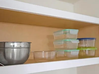 a shelf with bowls and containers on it at Charming Beach Studio With Pool & Sauna in Panama City Beach