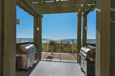 a screened in porch with a view of the beach at Emerald Isle 1504 in Panama City Beach