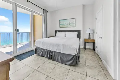 a bedroom with a bed and a large window at Ocean Villa 2004 by Emerald Coast Retreats Unit in Panama City Beach