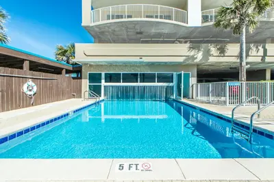a swimming pool with blue water in a building at Ocean Villa 2004 by Emerald Coast Retreats Unit in Panama City Beach