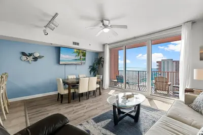 a living room with a couch and a table at Stylish 1BD Beachfront Condo with Amenities Galore! by Dolce Vita Getaways! in Panama City Beach