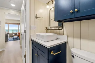 a bathroom with a sink and a blue cabinet at K and J Panama City Beach in Panama City Beach