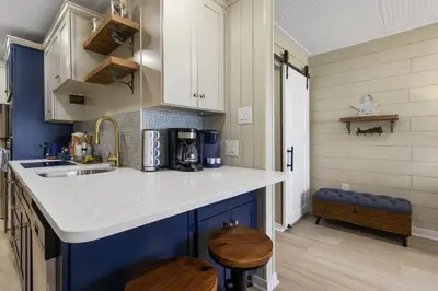 a kitchen with blue and white cabinets and a sink at K and J Panama City Beach in Panama City Beach