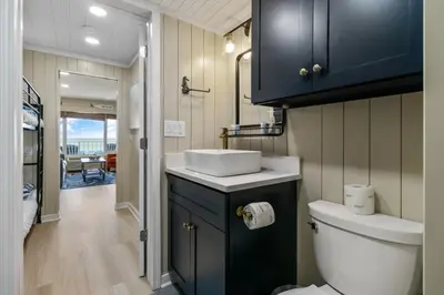 a bathroom with a white toilet and a sink at K and J Panama City Beach in Panama City Beach