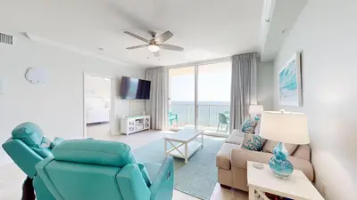 a living room with a couch and a chair at Tidewater 1005 in Panama City Beach