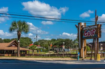 a sign for a restaurant with a palm tree at Tidewater 1005 in Panama City Beach