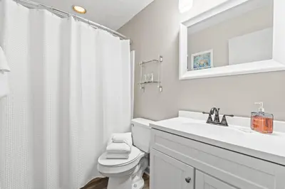 a white bathroom with a sink and a toilet at Nautical Watch #E-7 by Book That Condo in Panama City Beach