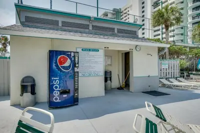 a building with a drink sign in front of it at Nautical Watch #E-7 by Book That Condo in Panama City Beach