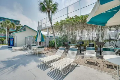a group of chairs and tables and umbrellas at Nautical Watch #E-7 by Book That Condo in Panama City Beach