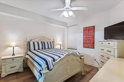 a bedroom with a bed and a ceiling fan at 601 Grandview East in Panama City Beach