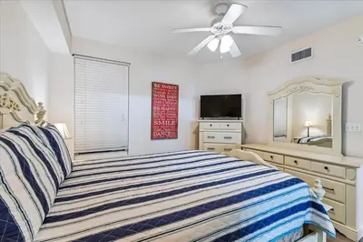a bedroom with a bed and a ceiling fan at 601 Grandview East in Panama City Beach