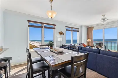 a dining room with a table and a couch at 601 Grandview East in Panama City Beach