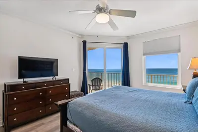 a bedroom with a bed and a flat screen tv at 601 Grandview East in Panama City Beach