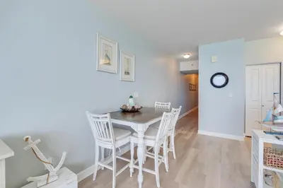 a kitchen and dining room with a table and chairs at 930 Shores Of Panama in Panama City Beach