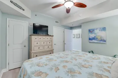 a bedroom with a bed and a ceiling fan at 930 Shores Of Panama in Panama City Beach