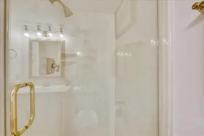 a bathroom with a shower with a glass door at 203 Moondrifter in Panama City Beach