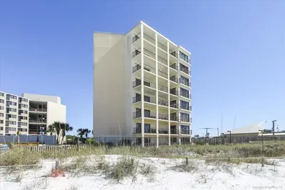 a building on the beach next to the beach at 203 Moondrifter in Panama City Beach