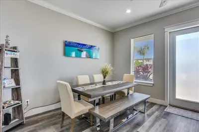 a dining room with a table and chairs and a window at A Shore Thing- A in Panama City Beach