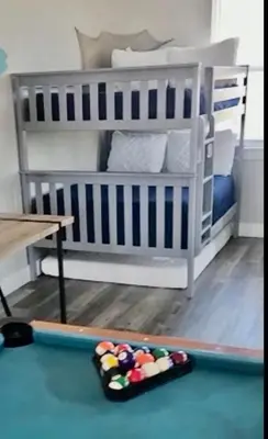 a crib in a room with a bed and a table at A Shore Thing- A in Panama City Beach