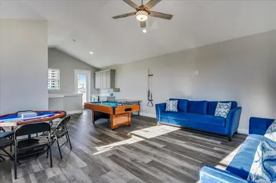 a living room with a blue couch and a table at A Shore Thing- A in Panama City Beach