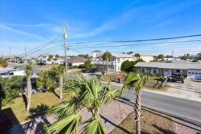 a view of a street with palm trees and houses at A Shore Thing- A in Panama City Beach