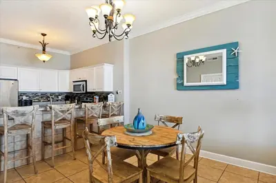 a kitchen and dining room with a table and chairs at 2102 Ocean Villa in Panama City Beach