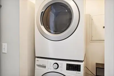 a washing machine sitting on top of a microwave at 2102 Ocean Villa in Panama City Beach