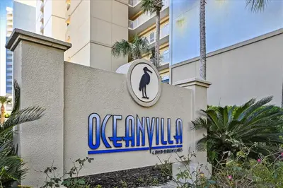 a sign for a building with a penguin on it at 2102 Ocean Villa in Panama City Beach