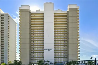 a large building with a sign on the side of it at 2102 Ocean Villa in Panama City Beach