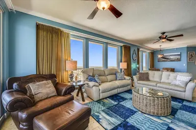 a living room with a couch and a table at 1909 Seychelles in Panama City Beach