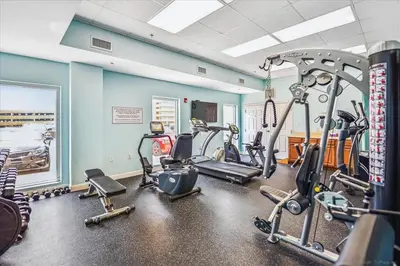 a gym with several treadmills and exercise bikes at 1909 Seychelles in Panama City Beach