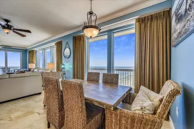 a dining room with a table and chairs at 1909 Seychelles in Panama City Beach