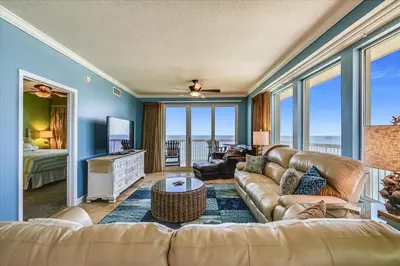 a living room with a couch and a television at 1909 Seychelles in Panama City Beach
