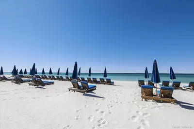 a row of chairs and umbrellas on a beach at 1409-Seychelles in Panama City Beach