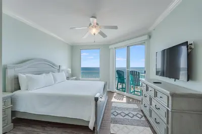 a bedroom with a bed and a flat screen tv at 305 Marisol in Panama City Beach