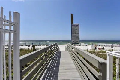 a boardwalk leading to a beach with the ocean at 305 Marisol in Panama City Beach