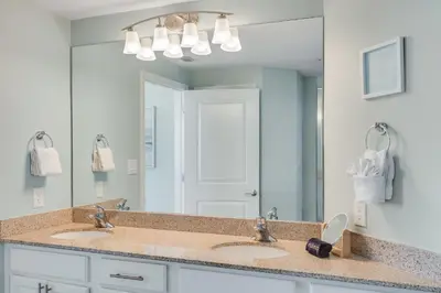 a bathroom with two sinks and a large mirror at 305 Marisol in Panama City Beach