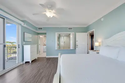 a bedroom with a bed and a ceiling fan at 305 Marisol in Panama City Beach