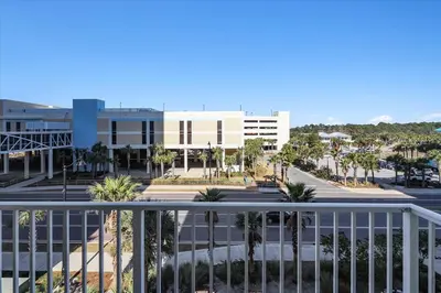 arial view of a building with palm trees and a street at 305 Marisol in Panama City Beach