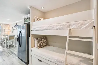 a dorm room with bunk beds and a refrigerator at #17 Latitude 29 in Panama City Beach