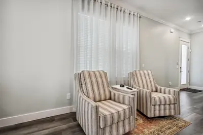 two chairs in a living room with a window at Starfish Shores in Panama City Beach