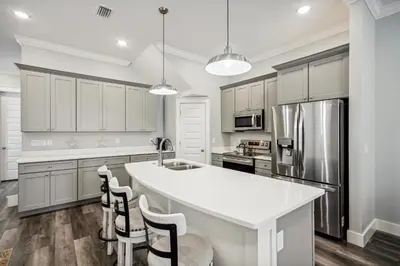 a kitchen with a white counter top and a refrigerator at Starfish Shores in Panama City Beach