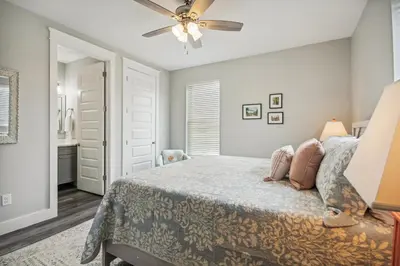 a bedroom with a bed and a ceiling fan at Starfish Shores in Panama City Beach