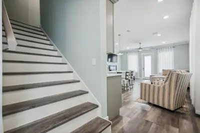 a staircase leading to a living room and dining room at Starfish Shores in Panama City Beach