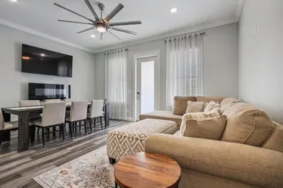 a living room with a couch and a dining room at Starfish Shores in Panama City Beach