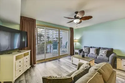 a living room with a couch and a flat screen tv at 225-Shores Of Panama in Panama City Beach